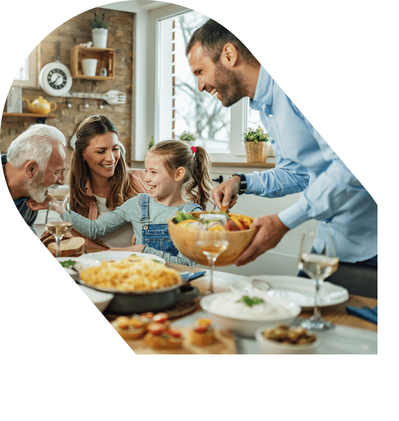 Happy multi-generation family gathering around dining table and having fun during a lunch 